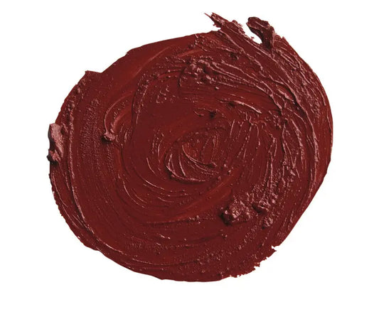 Close-up of a swatch of deep cranberry red lipstick on a white background