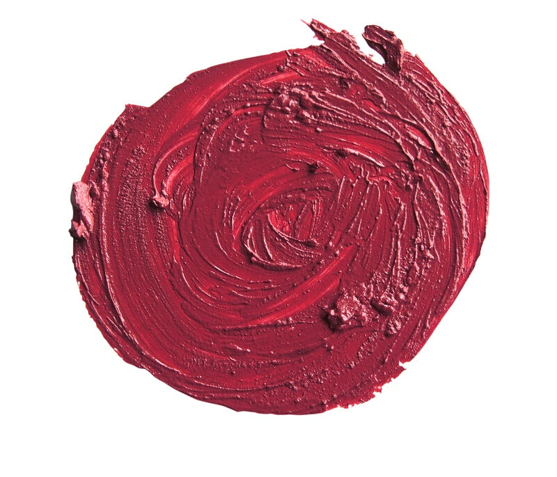 Close-up of a swatch of red lipstick on a white background