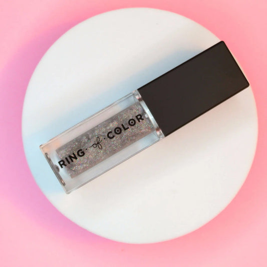 silver glittery lip oil with 'Ring of Color' text on a gradient pink and white background