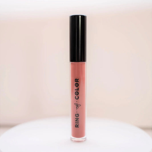 Lip gloss with black cap and 'Ring of Color' branding on a white surface.