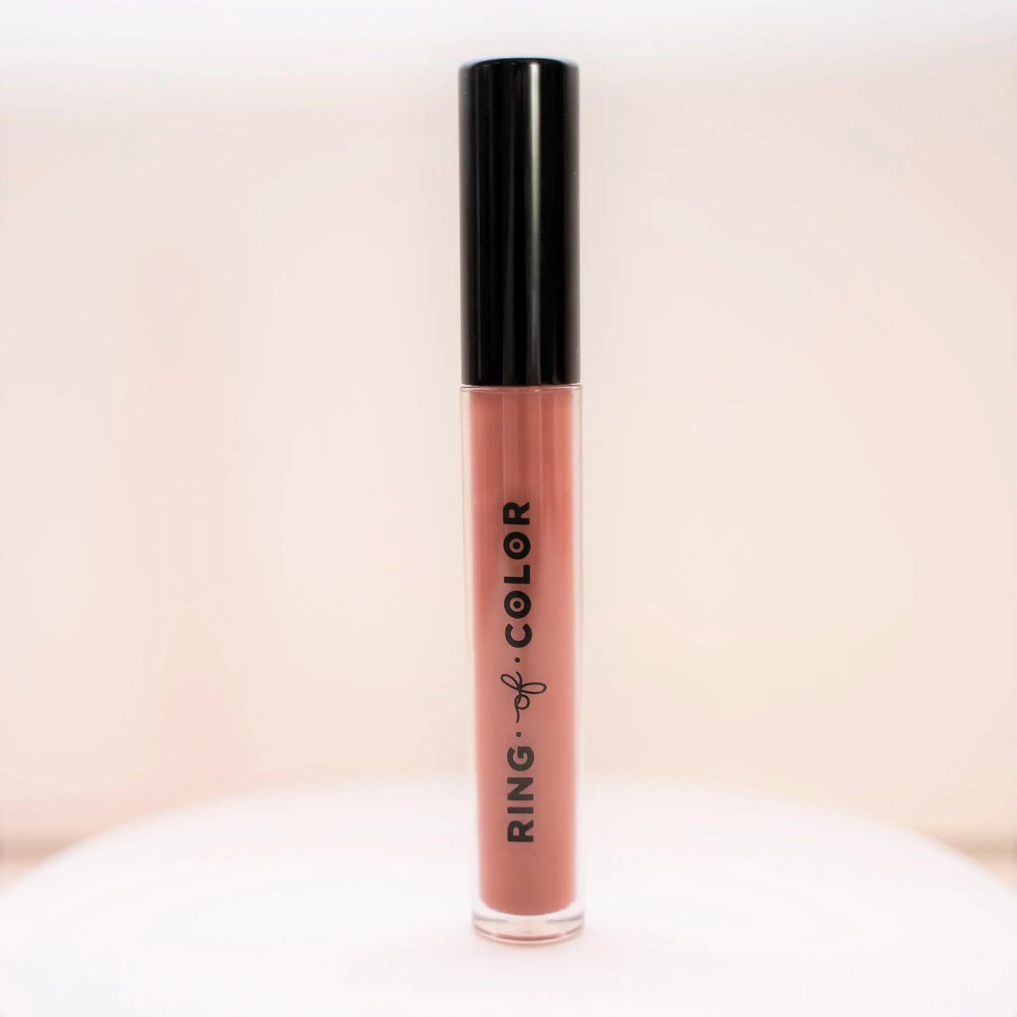 taupe medium brown Lip gloss with black cap and 'Ring of Color' branding on a light background
