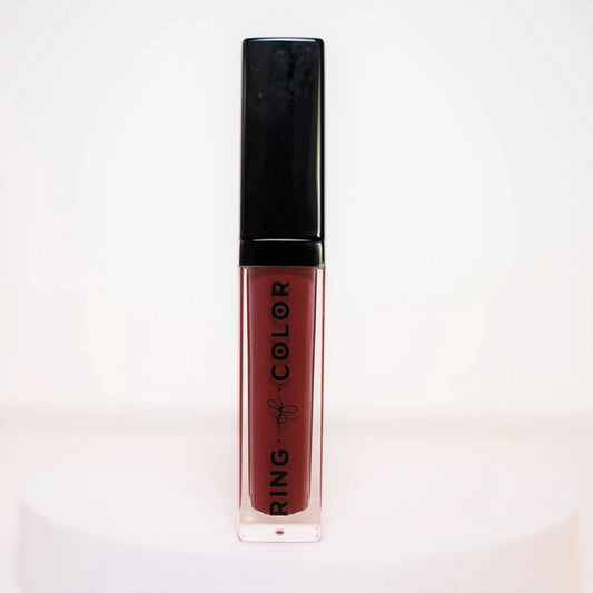 Deep cranberry Lipstick with black cap and visible brand name on a light background