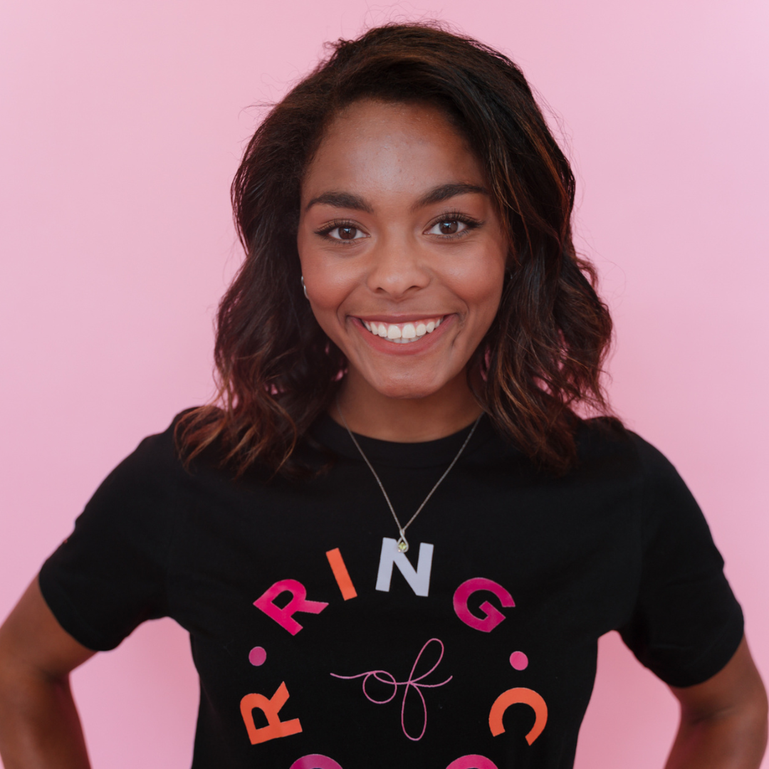 dark skin model with black tshirt with ring of color logo